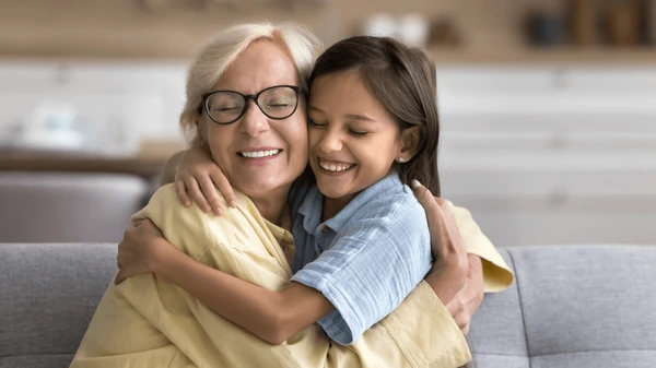 Abuela y nieta abrazándose tiernamente, simbolizando el amor y la conexión familiar.