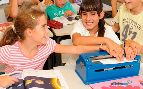 Niños de diversas edades estudiando en un aula, reflejando la educación inclusiva y obligatoria del Artículo 3 de la Constitución Mexicana.